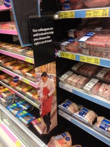 A focus on staffing sees a colleague dressed in butcher's attire on the aisle. 