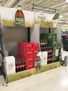 A Produce chiller converted to a Coke Life display.